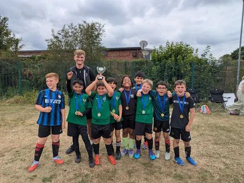 Boys lifting a summer tournament cup