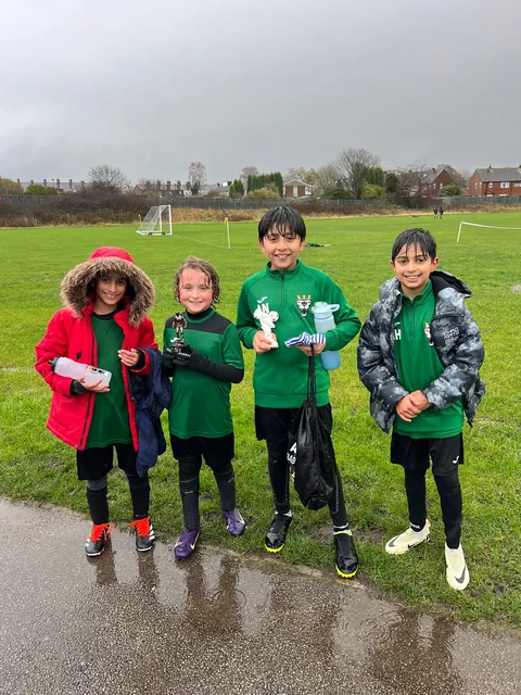 Rainy-day football, boys still smiling