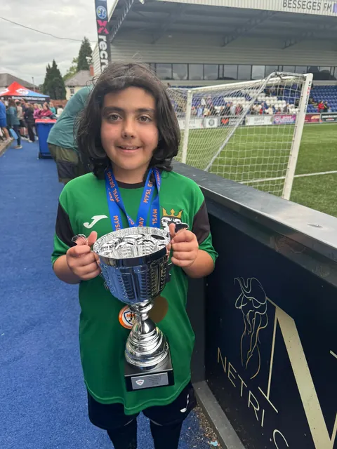 A player holding the cup with a big smile