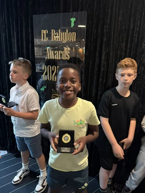 A young player proudly showing his award