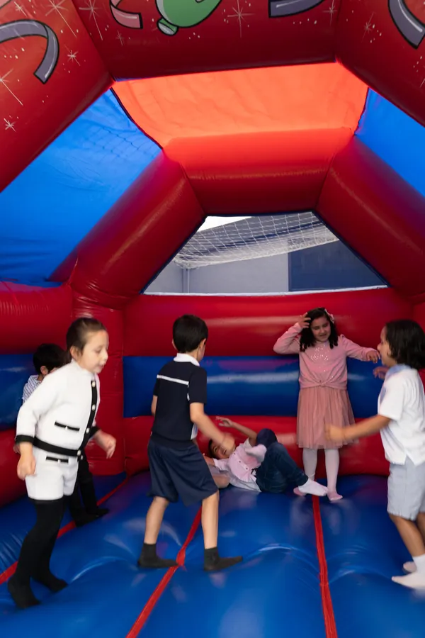 Children playing on the bouncy castle at the 2024 awards day