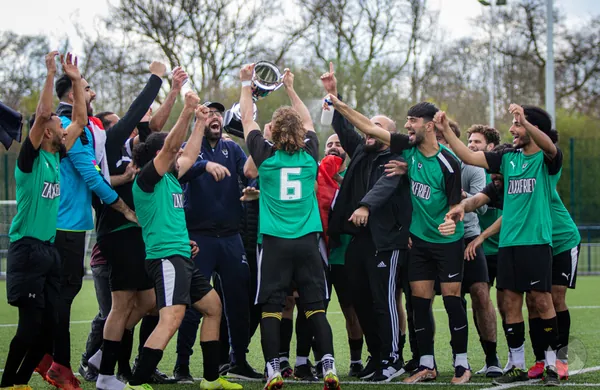 The FC Babylon adult side celebrating their league title with the trophy
