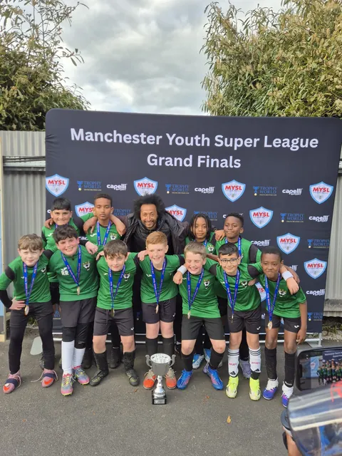 The U11s squad with the cup at the Manchester Youth Super League Grand Finals